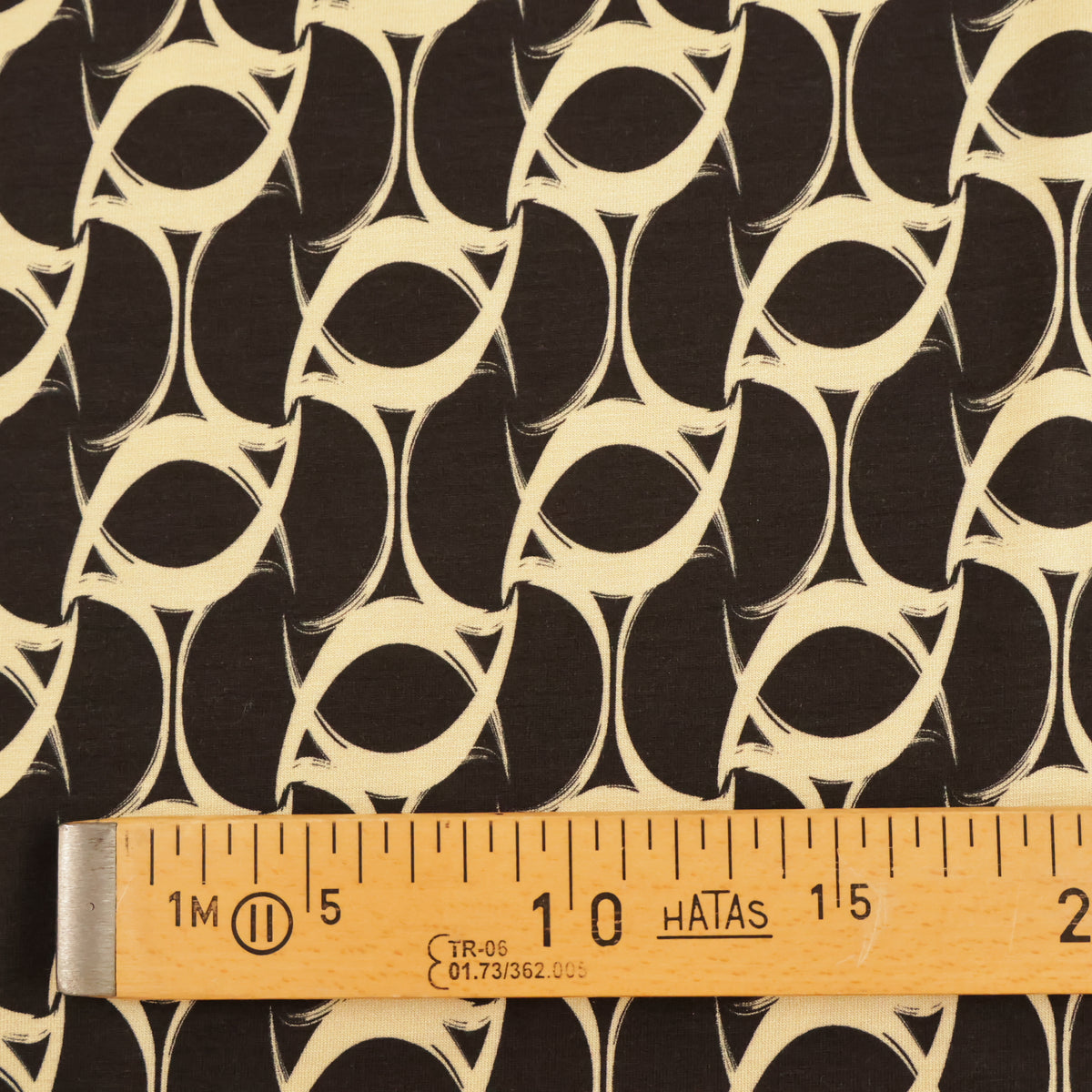 Jersey tourbillon beige sur fond noir